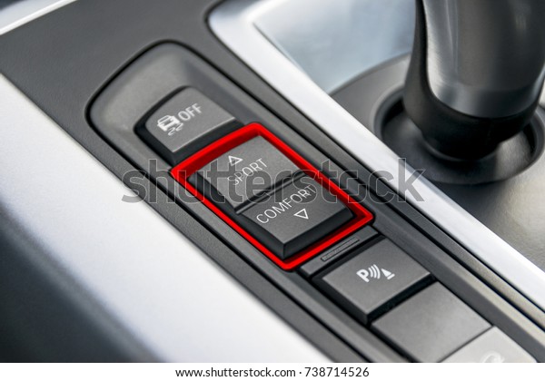 Track control buttons near automatic\
gear stick of a modern car, car interior\
details