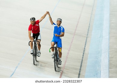 Track cyclists celebrating in velodrome - Powered by Shutterstock