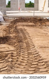 Track Marks Left By Heavy Machinery In Sand Near Foundation Of Concrete Single-family House Under Construction In Southwest Florida