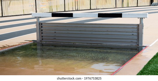 Track Steeplechase With A Full Water Pit Is Set Up And Ready For A High School Boys Running Race