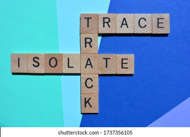 Track, Trace, Isolate, Crossword In Wooden Alphabet Letters Isolated On Blue