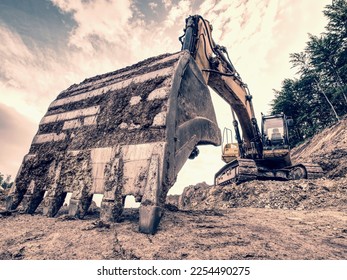 Track type loader is mining stones in opencast mining quarry. Heavy machinery in the open pit, excavators, dozers and trucks. Digging and excavation operations