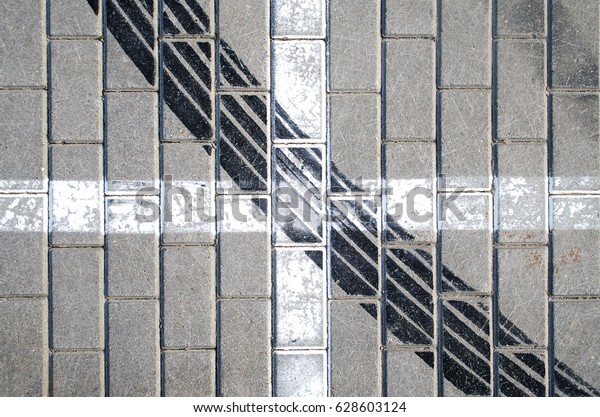 Track\
wheel protector on the tile in the parking\
lot