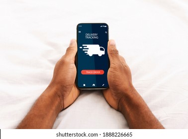 Track Your Order Online. Point Of View Of Black Man Holding And Using His Smartphone With Delivery Tracking Service Application, Cheking Status Of Domestic And International Shipments Via Internet