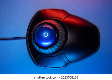 Trackball Computer Mouse on a blue background. Control Device with Scroll Wheel. Top View