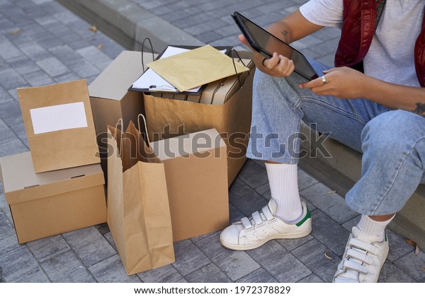Tracking order. Young asian male courier looking at\
map on digit
