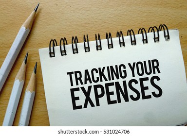 Tracking Your Expenses Text Written On A Notebook With Pencils