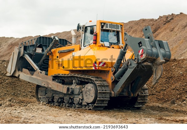 Track-type bulldozer.\
\
Land clearing, grading, utility trenching.\
Earth-moving\
equipment.