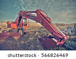 track-type loader excavator machine doing earth moving work at green field