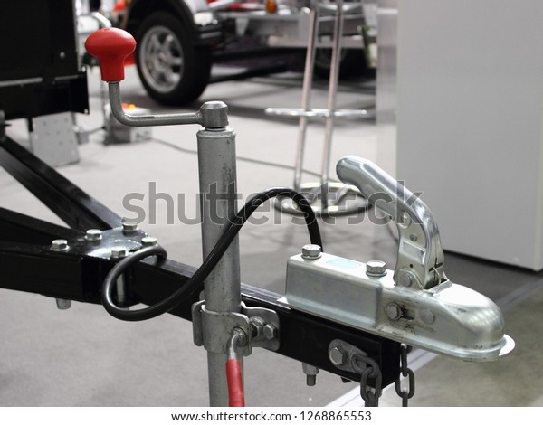 traction device - handle, wheel\
strut and the opened lock of the car trailer - towing,\
connection