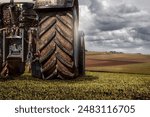 Tractor from behind in a field during harvest
