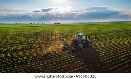 Tractor cultivating field at spring,aerial view 商業照片 © 