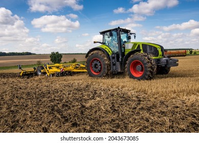 tractor with disc harrow, soil cultivation system in operation, plowed to prepare the soil for planting a new crop of agricultural crops - Shutterstock ID 2043673085