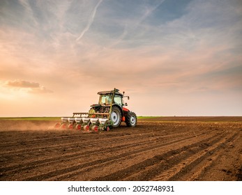 Tractor drilling seeding crops at farm field. Agricultural activity. - Shutterstock ID 2052748931