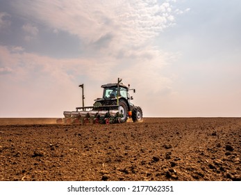 Tractor drilling seeding crops at farm. Agricultural activity. - Shutterstock ID 2177062351