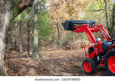 A tractor equipped with a front end loader is an efficient useful tool for moving brush and making paths through the timber.