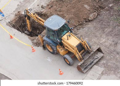 tractor excavator digging the ground to stop the  leaking in water pipes