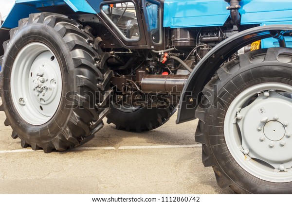 Tractor for farm work, modern\
agricultural transport working in the field, modern tractor\
close-up