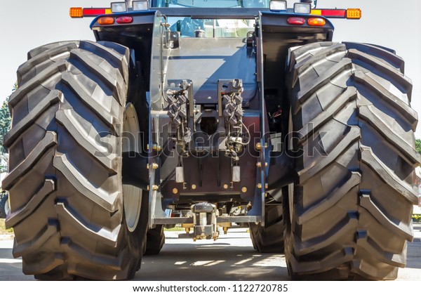 Tractor for farm work, modern\
agricultural transport working in the field, modern tractor\
close-up