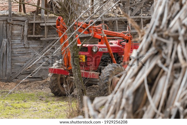 Tractor in farm yard. Agricultural machinery\
and equipment.