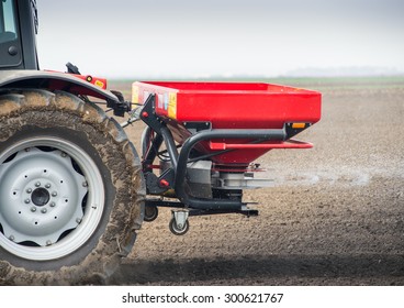 Tractor and fertilizer spreader in field