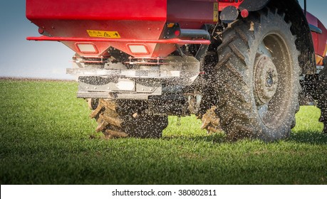  tractor fertilizing in wheat field 