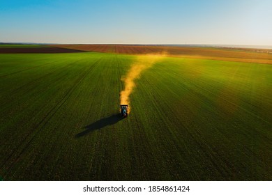 Tractor fertilizing wheat field, aerial view, hdr nature landscape.