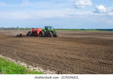 Tractor In The Field, Spring Sowing. Sowing Corn In The Field In Spring.