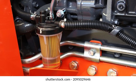 Tractor Fuel Filter. Transparent Fuel Filter With Black Rubber Hose Mounted On Tractor Side With Copy Space. Selective Focus