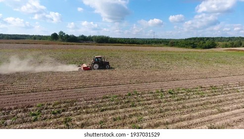 A Tractor Is Harvesting In The Field