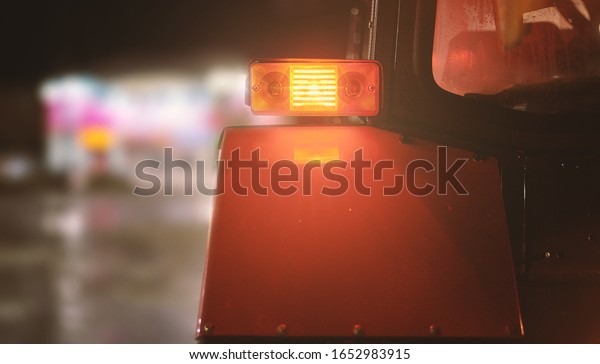 Tractor headlight\
close-up. Road cleaning\
work.