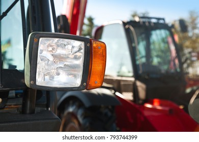 Tractor headlight, huge machine with light equipment also used for tractors, excavators, loaders and other machines, focused on spotlight, selective focus.