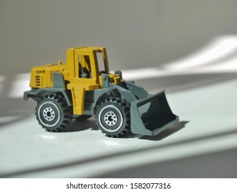 Tractor Or Loader Excavator For Earth Moving Works At Construction Site, Miniature Earth Mover Frontend Loader, Toy Loader Digger, Toy Industrial Vehicle.