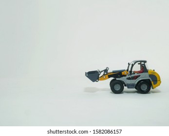 Tractor Or Loader Excavator For Earth Moving Works At Construction Site, Miniature Earth Mover Frontend Loader, Toy Loader Digger, Toy Industrial Vehicle.