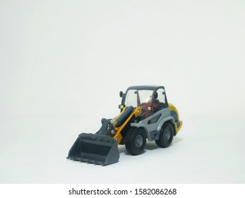 Tractor Or Loader Excavator For Earth Moving Works At Construction Site, Miniature Earth Mover Frontend Loader, Toy Loader Digger, Toy Industrial Vehicle.