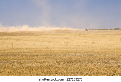 A Tractor And Machinery Raises A Dust Plume On An Australian Farm