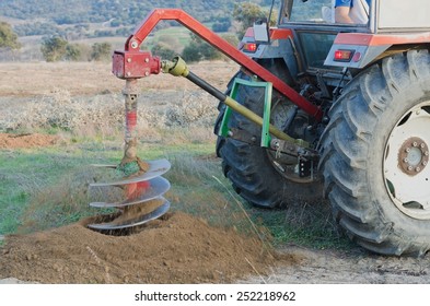 Tractor Making A Hole With An Auger