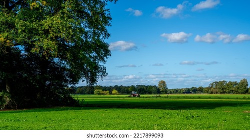 Tractor Mowing Grass In A Meadow
