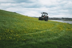 Tractor On The Farm In The Flower Field Near Silverstrand Beach In Galway, Ireland 