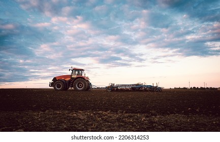 Tractor on field tilling the soil - Shutterstock ID 2206314253