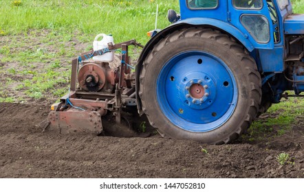 Tractor plowing soil in spring .