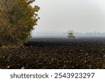 The tractor plows the land in autumn, for sowing. Image of agriculture