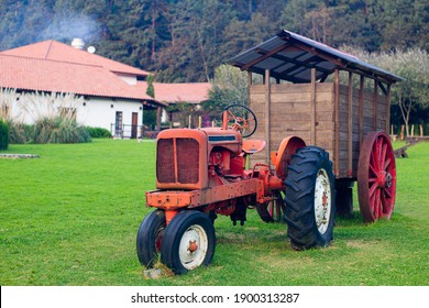 Tractor Pulling An Old Wooden Cart