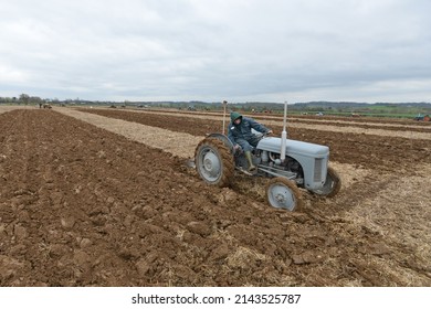 A tractor pulls a plough through a field during a vintage ploughing meet on April 4, 2015 in Wingfield, UK. Widespread use of tractors emerged during mechanisation of the agriculture in the 1950s.