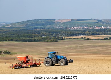 Tractor With Seed Drill In Early Spring Landscape