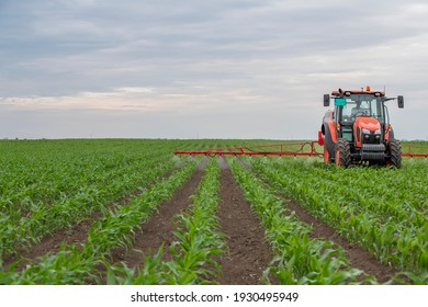 Tractor spray fertilize field with insecticide herbicide chemicals in agriculture field 