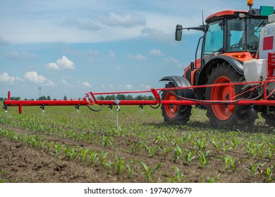 Tractor Spray Fertilize Field With Insecticide Herbicide Chemicals In Agriculture Field 