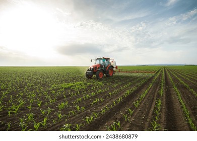 Tractor spray fertilize field with insecticide herbicide chemicals in agriculture field 