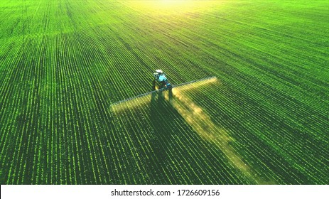 Tractor spray fertilizer on green field drone high angle view, agriculture background concept. - Shutterstock ID 1726609156