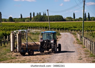 Tractor With Spray Unit Attached On Vineyard In Hawkes Bay, NZ